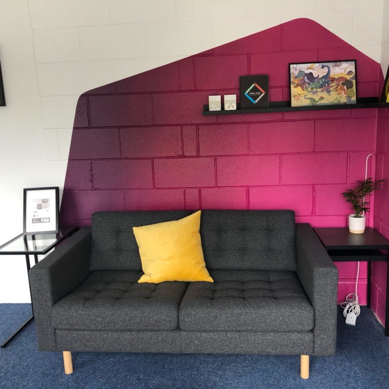 Pink wall art and sofa