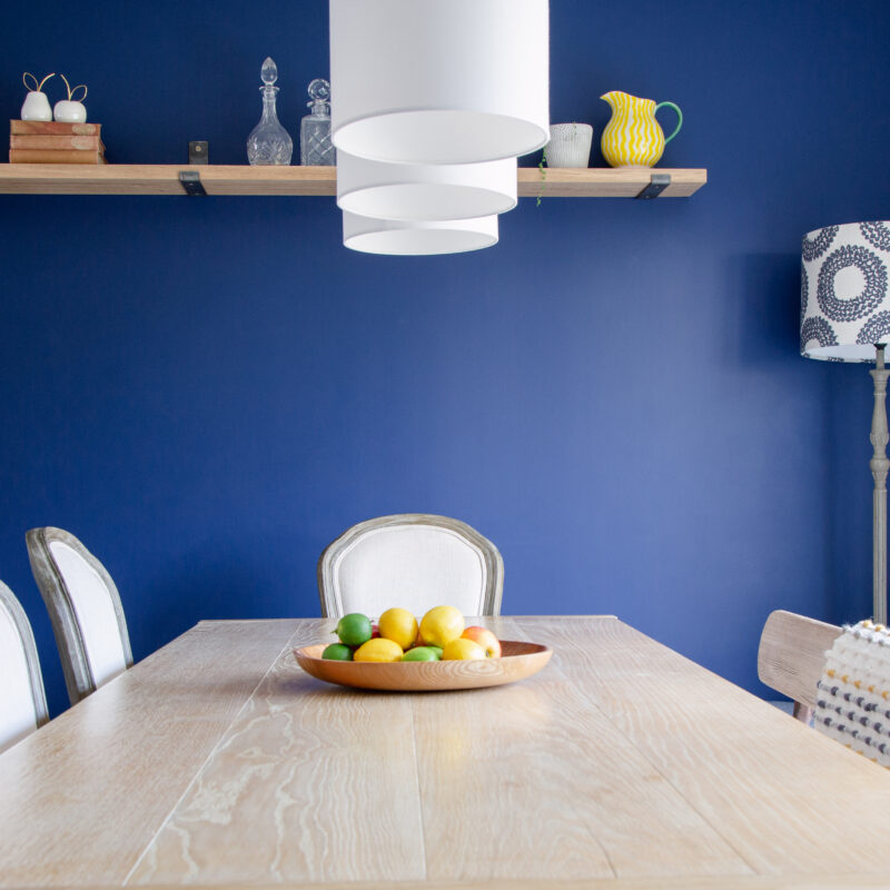 Blue wall dining room with table and chairs