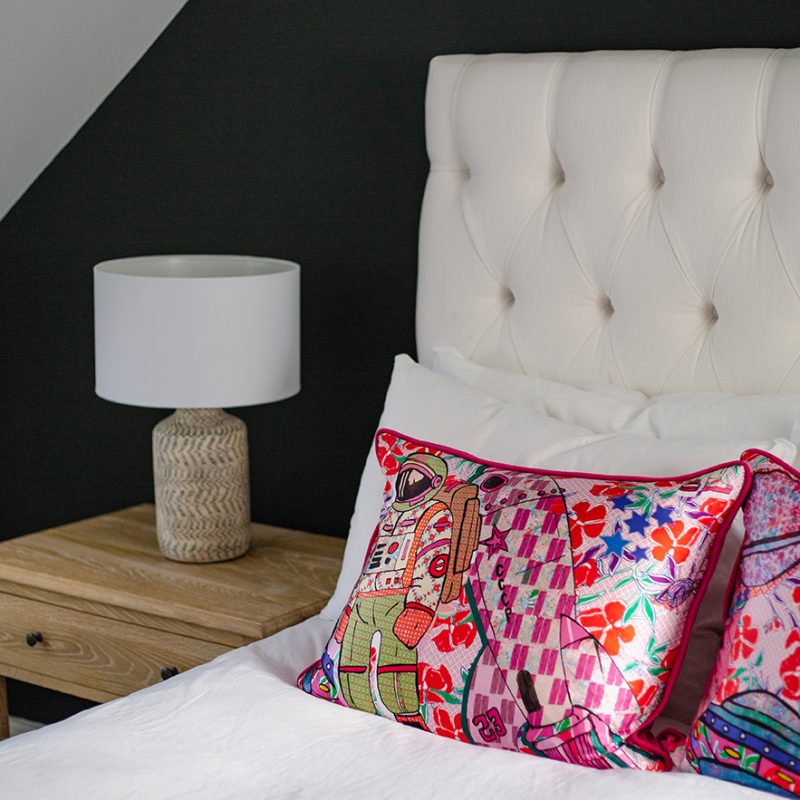 White bed and pink cushions