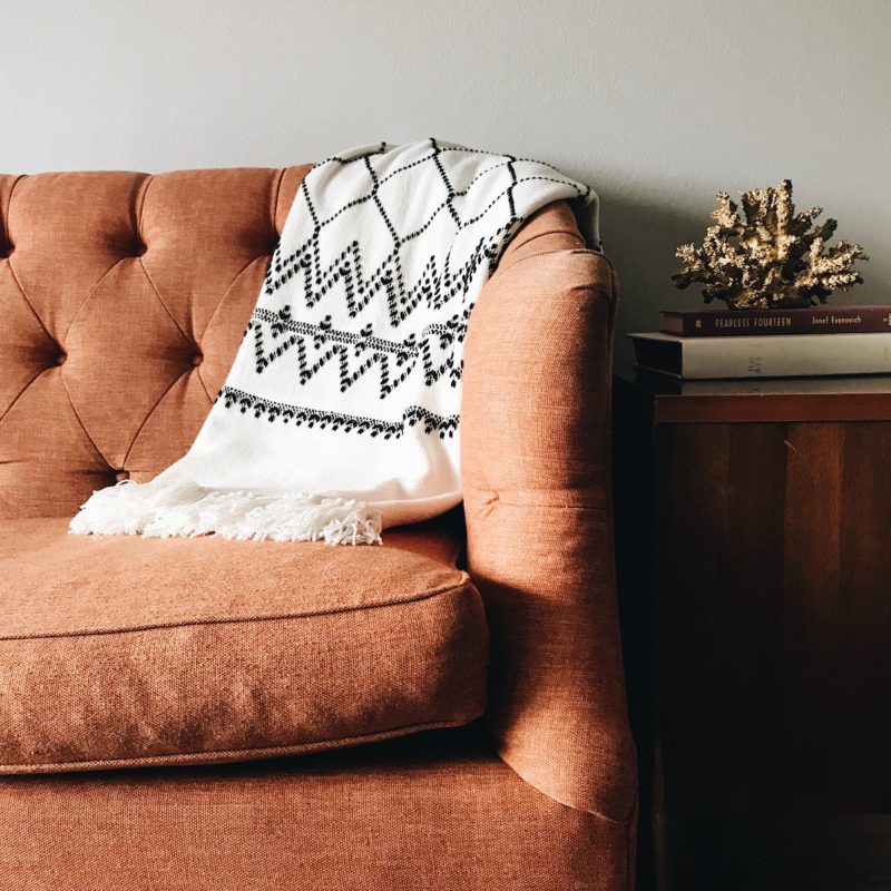 Orange sofa with neutral interior