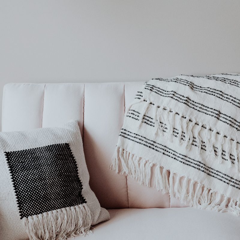 white sofa with a cushion