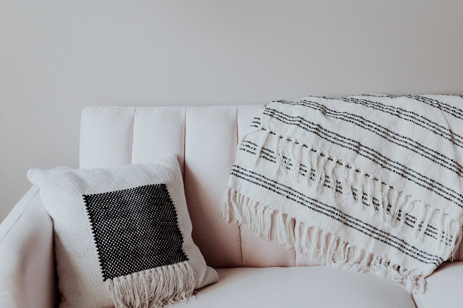 white sofa with a cushion